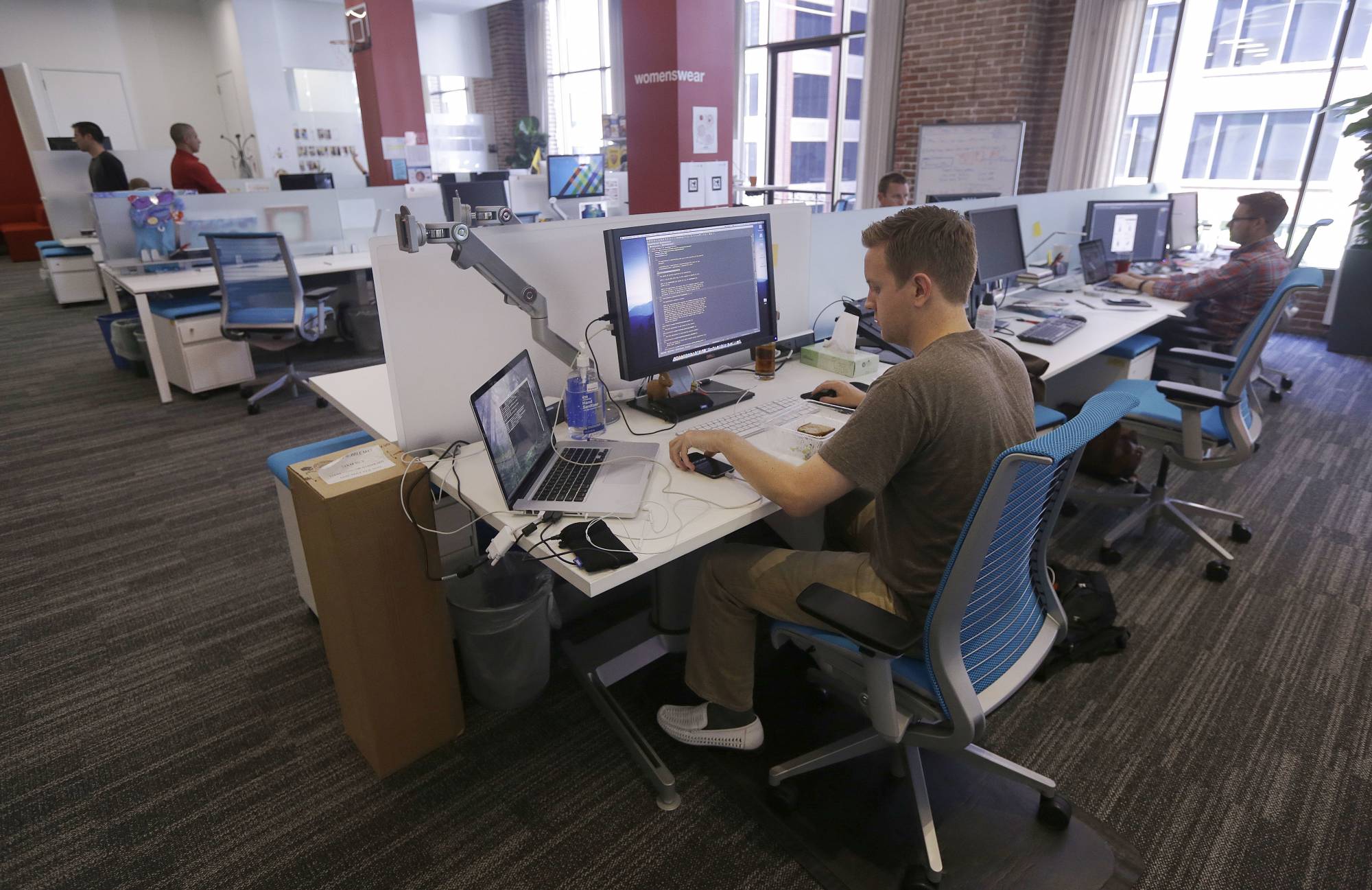 FILE- This Sept. 19, 2013, file photo shows workers at the Target Technology Innovation Center office in San Francisco.  The job market has changed under President Barack Obama's 8 years.  Young people are flooding in as the elderly retire.   (AP Photo/Jeff Chiu, File)